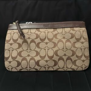 Brown Coach signature logo design pouch.